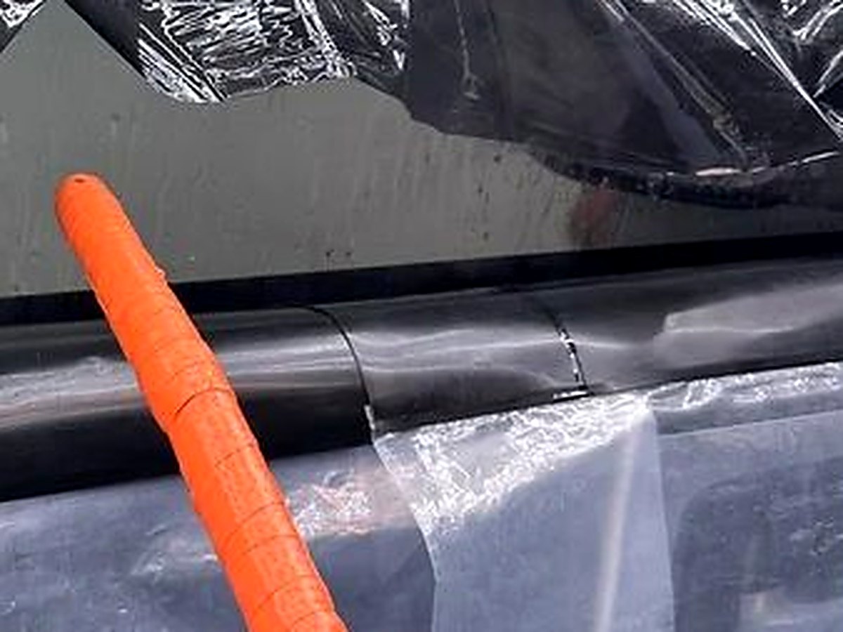 Old failing window tint being professionally peeled and removed at Rosie's Window Tint